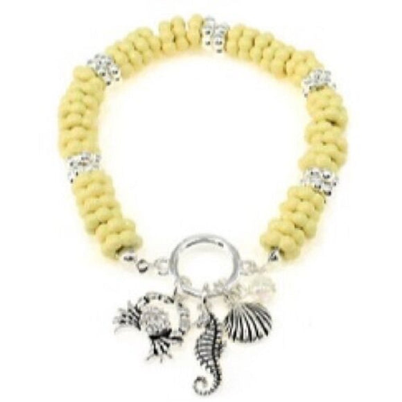 IVORY BEADED STRETCH BRACELET WITH SILVER SEA ANIMAL THEME CHARMS ( 06196 )